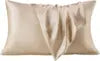 Two beige pillows on a white background