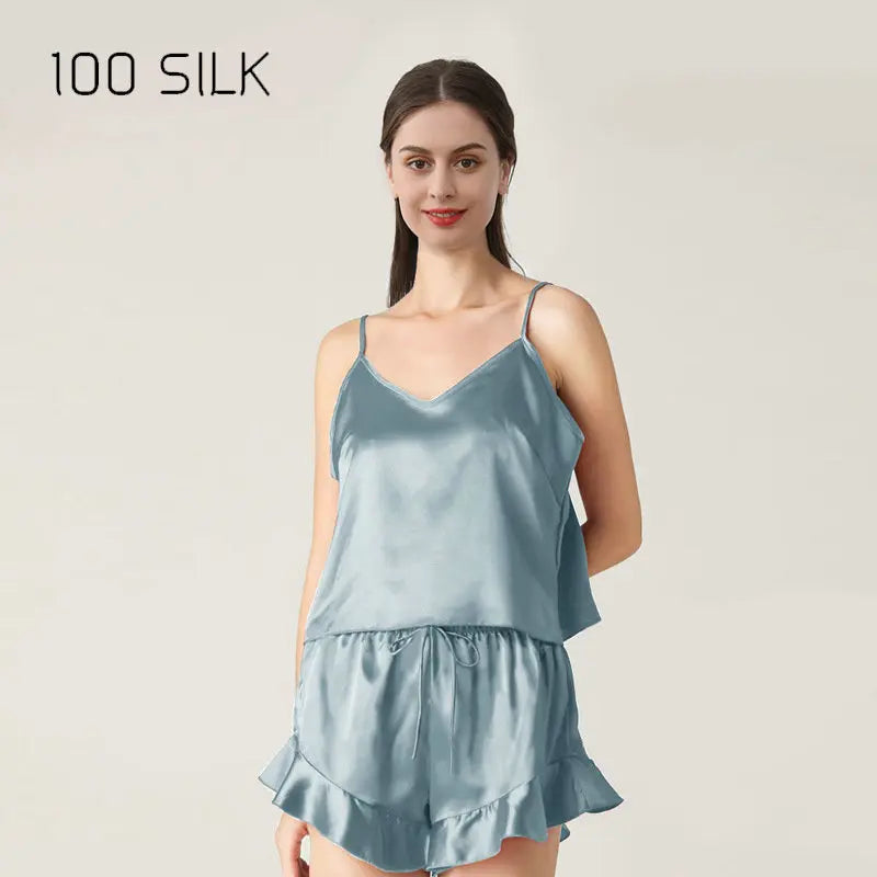 Woman wearing a light blue satin nightgown with '100 SILK' text above.