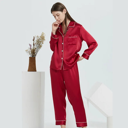 Woman wearing red blue pajamas with white trim on a white background