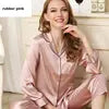 Woman wearing a pink pajama set with a white background