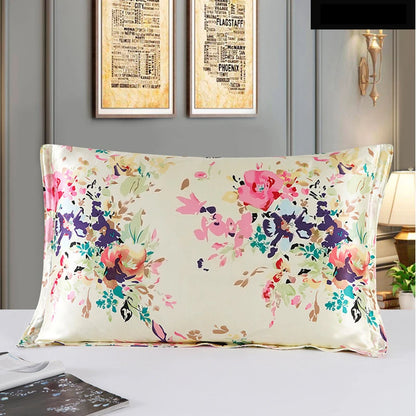 Floral-patterned pillow on a bed with framed artwork in the background