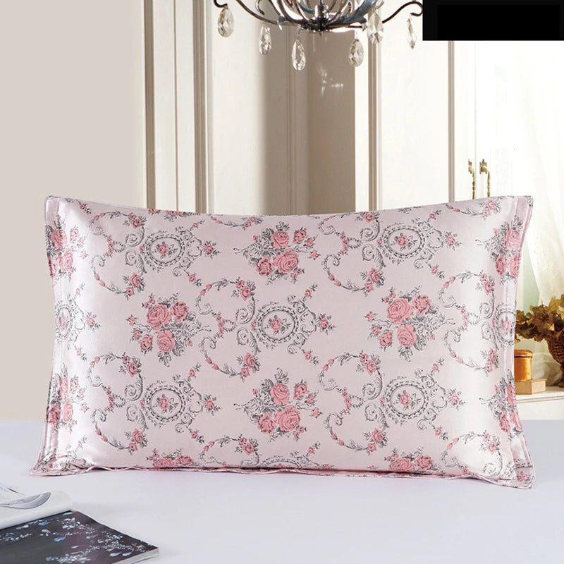 Floral patterned pillow on a white surface with a decorative chandelier in the background