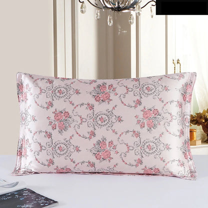 Floral patterned pillow on a white surface with a decorative chandelier in the background