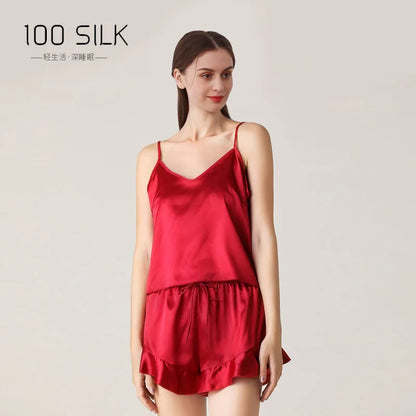 Woman wearing a red silk nightgown with '100 Silk' branding on a light background