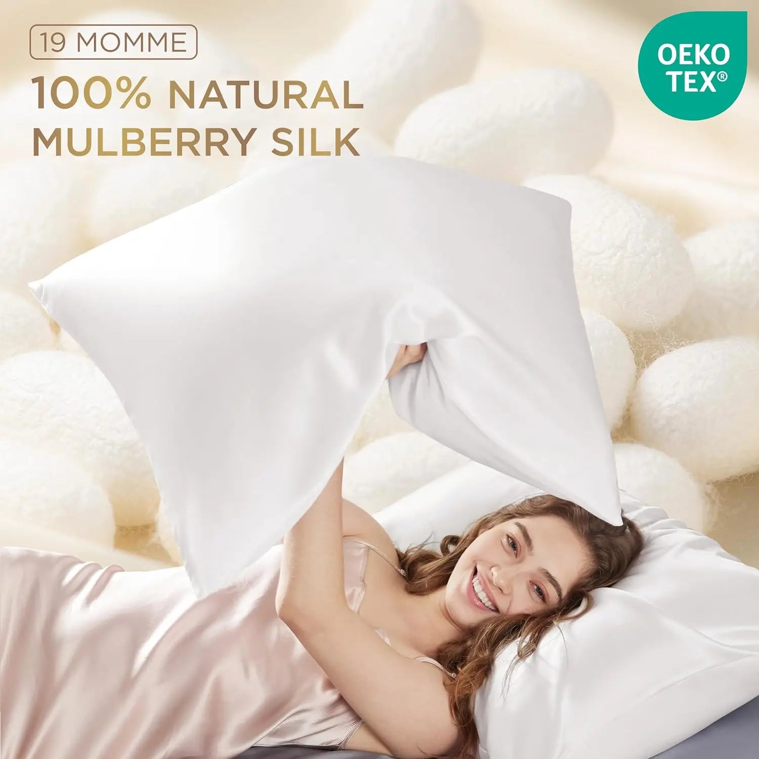 Woman lying on a bed with white pillows, surrounded by mulberry silk fibers, with '19 Momme 100% Natural Mulberry Silk' text and Oeko-Tex logo.