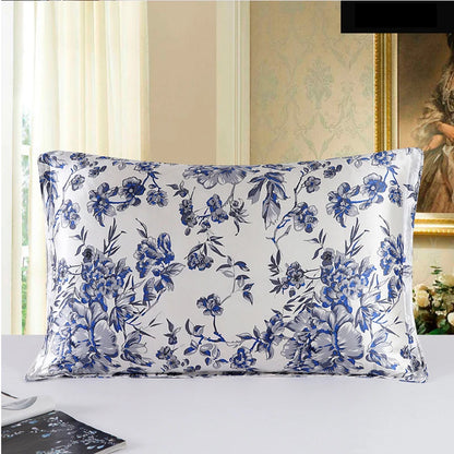 Floral patterned pillow on a bed with a decorative wall in the background