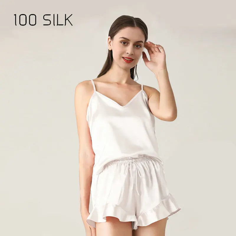 Woman wearing a white silk nightgown with '100 Silk' text on a plain background