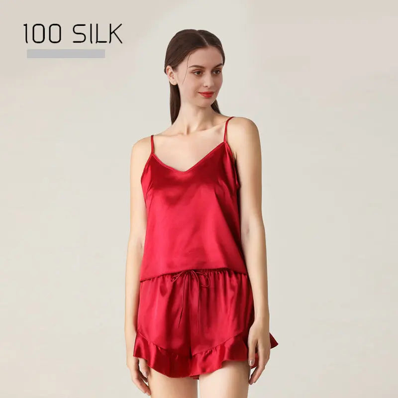 Woman wearing a red silk nightgown with '100 Silk' text on a light background