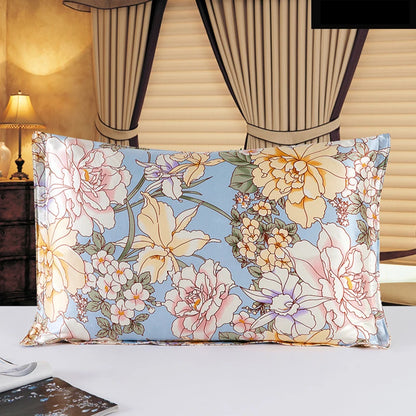 Floral patterned pillow on a bed with curtains and lamp in the background