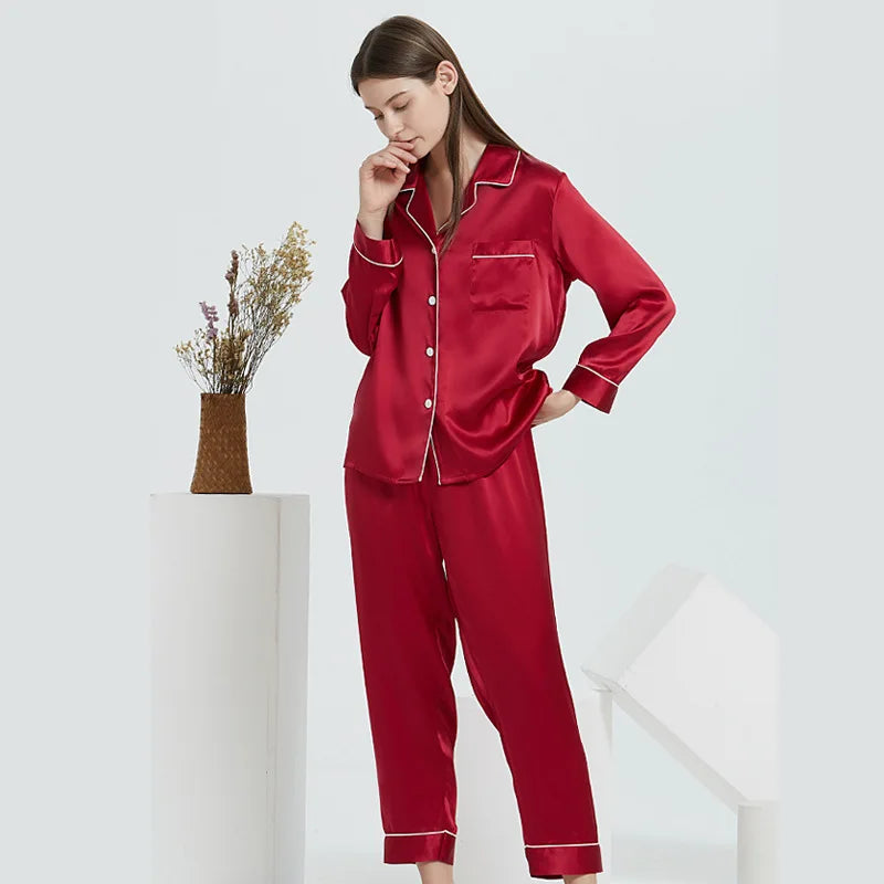 Woman wearing red satin pajamas on a white background