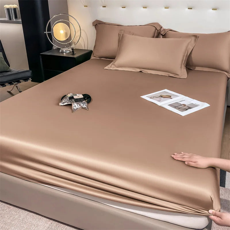 Brown satin sheet set being shown on a bed in a bedroom setting.