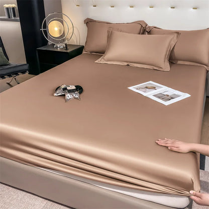 Brown satin sheet set being shown on a bed in a bedroom setting.