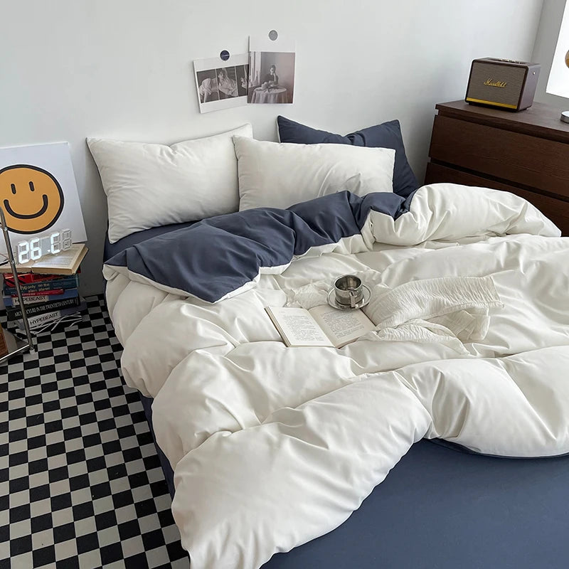 Bed with white and blue bedding in a room with a checkered floor and a nightstand.