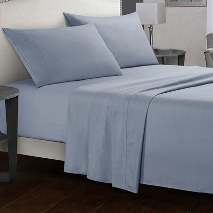 Blue bed sheets and pillows on a bed in a bedroom setting.